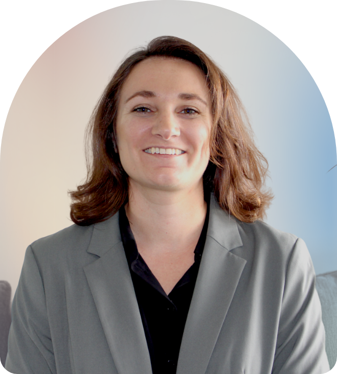 Headshot of Donna wearing a blazer in front of a gradient background
